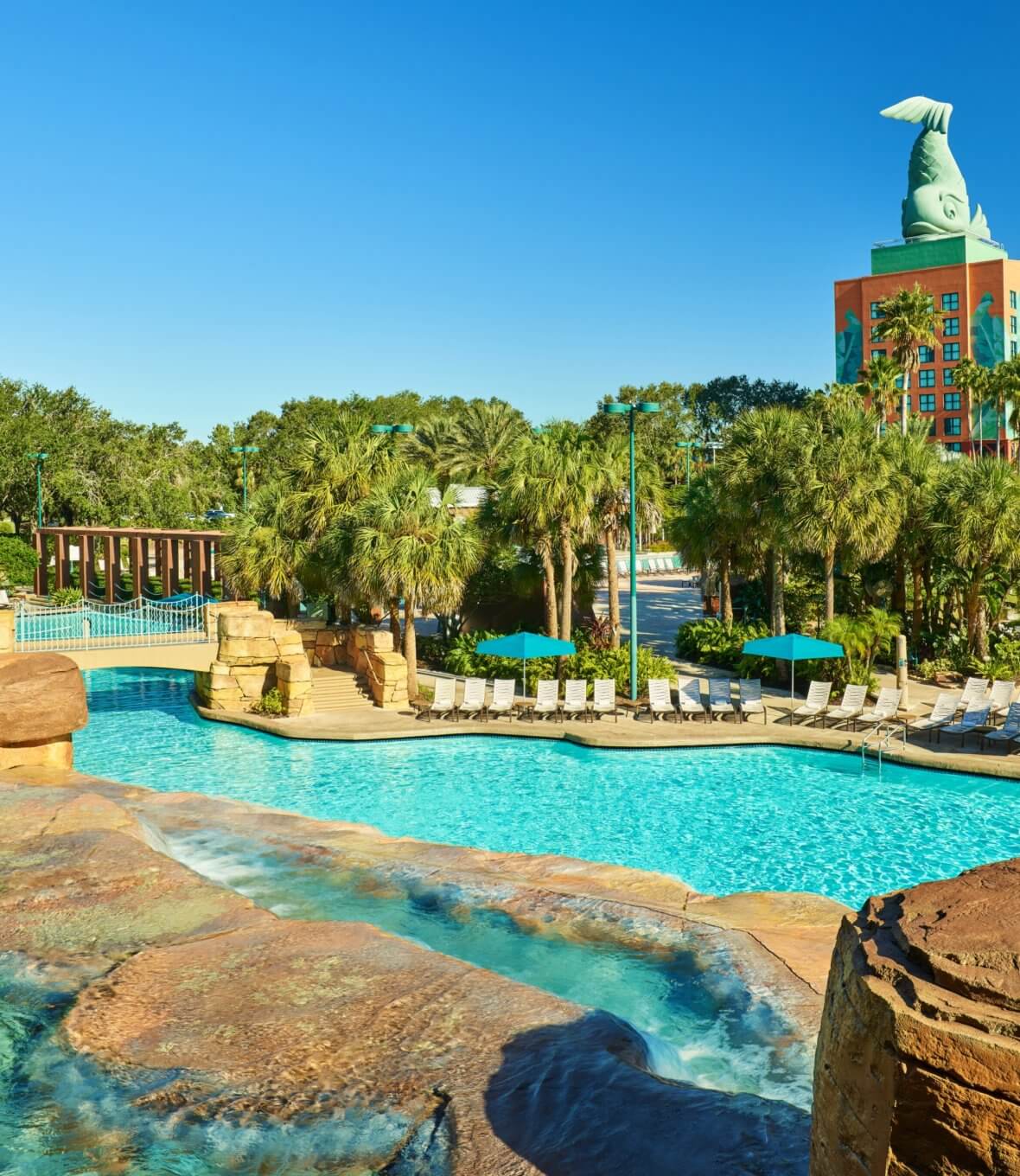 Grotto Pool with Chairs, Umbrellas and Dolphin Hotel in the Background