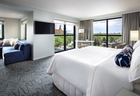 Swan Family Room With Balcony, King Bed, Couch, Desk and Chairs